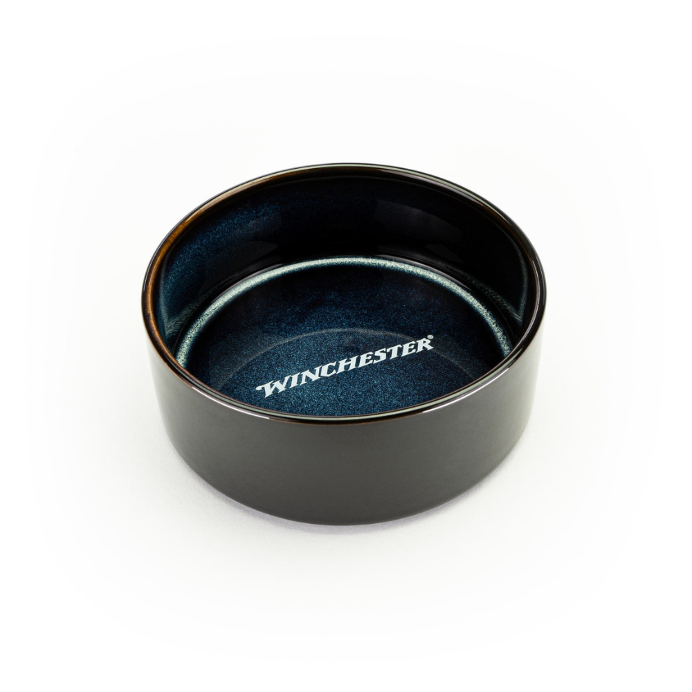 Black ceramic bowl with blue interior on a white background, featuring the Winchester logo.