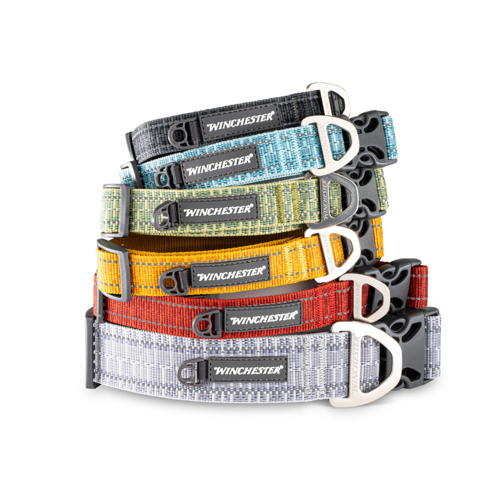 Stack of Winchester dog collars in various colors on a white background