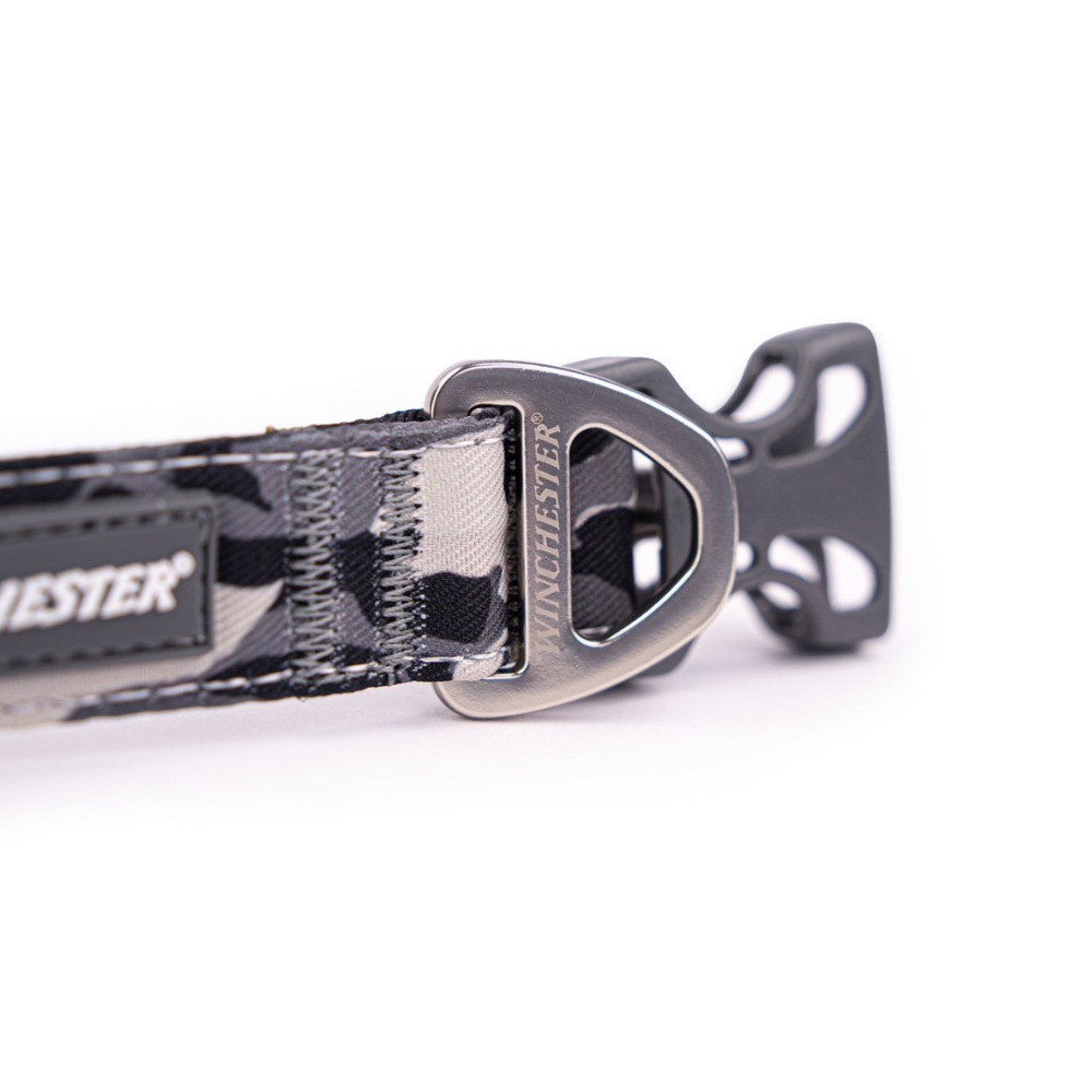 Dog collar with camouflage pattern and metal buckle on a white background